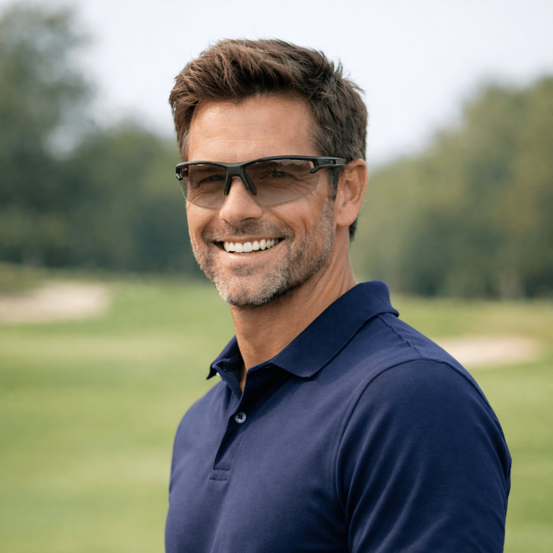 Matte Carbon | DUBL Helios Golf Sunglasses with ShotSync™, man on golf course