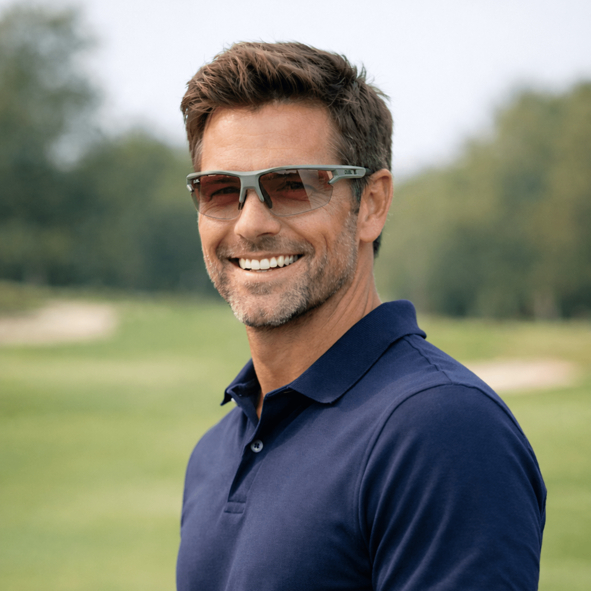 Matte Pebble | DUBL Helios Golf Sunglasses with ShotSync™, man on golf course