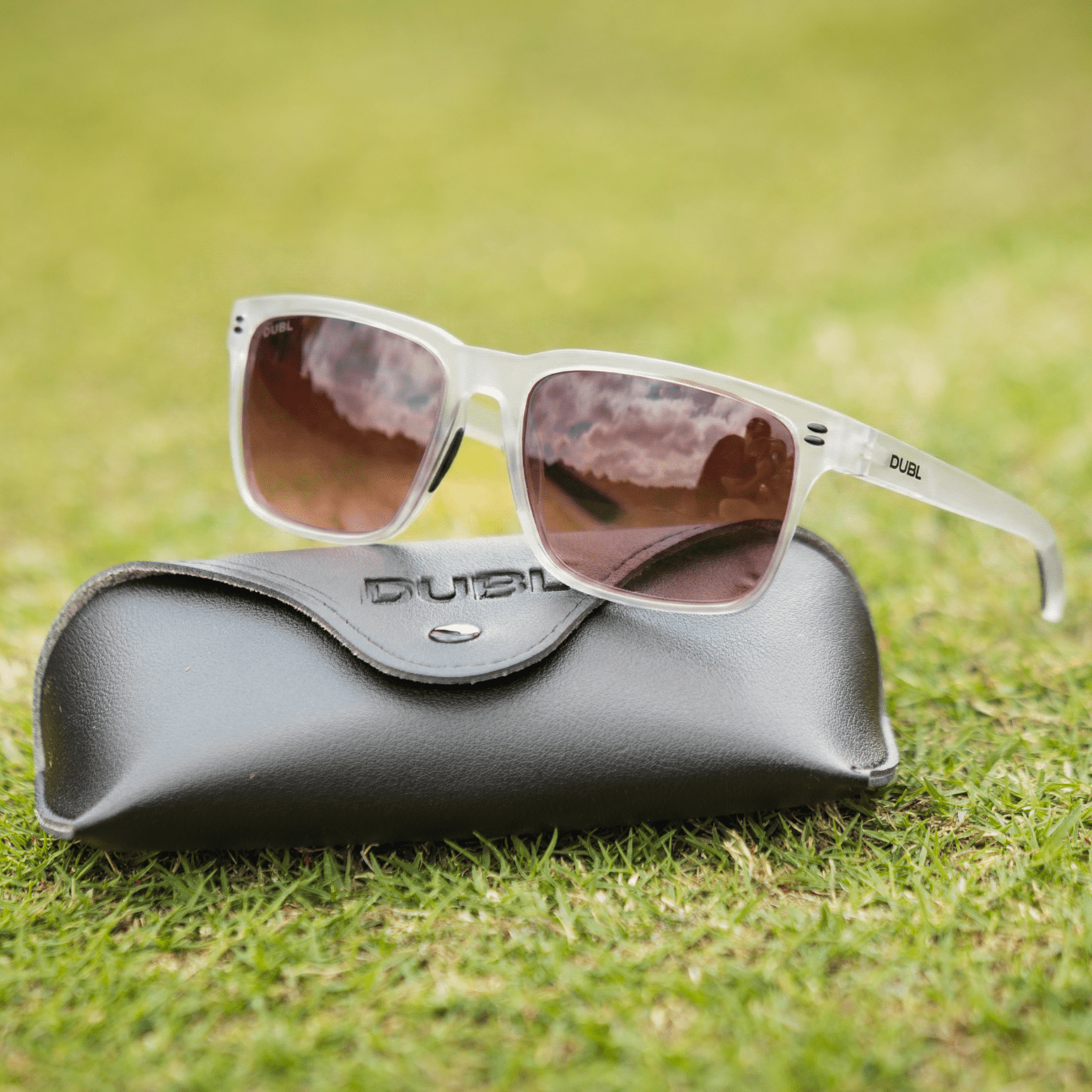 White | Sunglasses with a black frame and red lenses on a black case