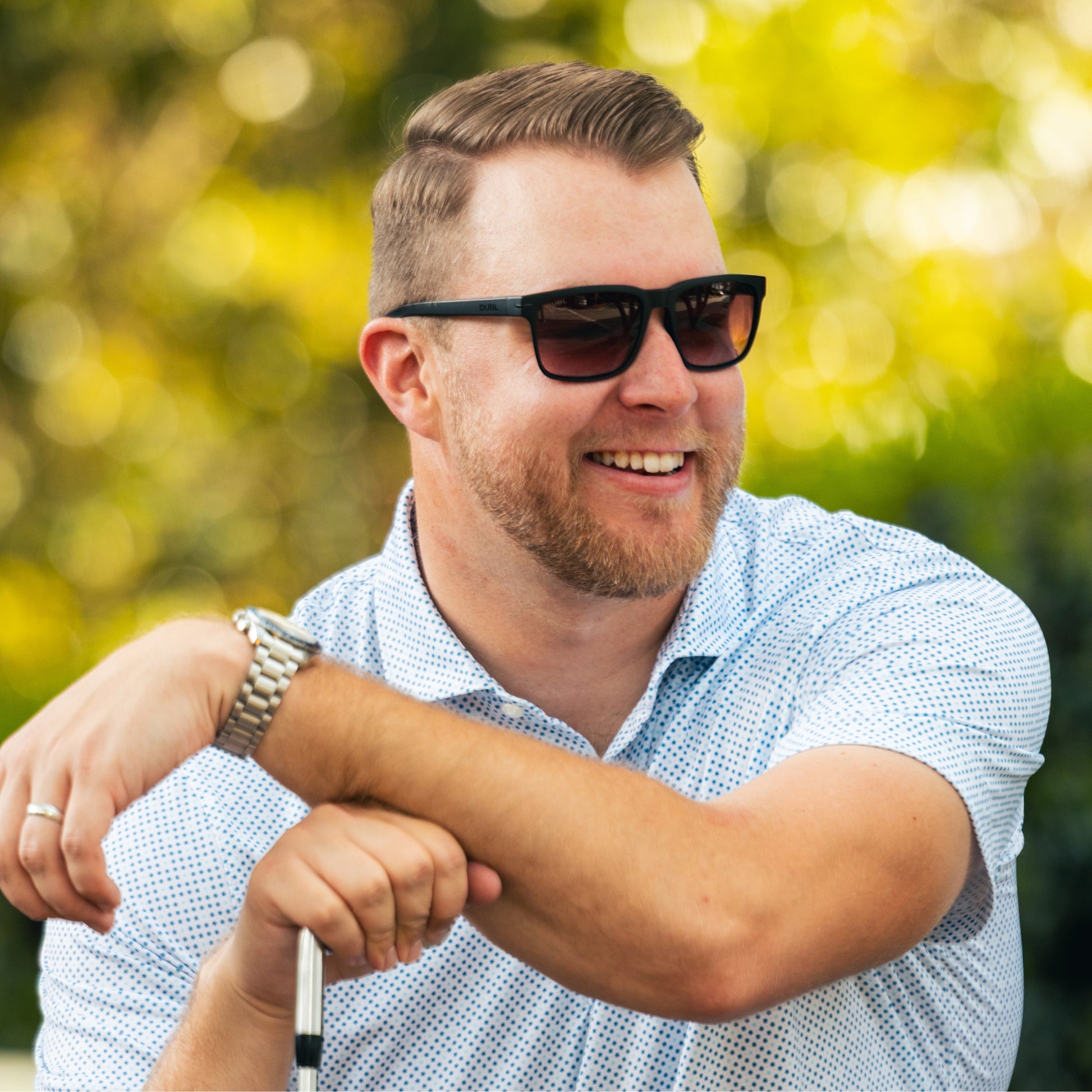 Man wearing golf sunglasses that track the ball