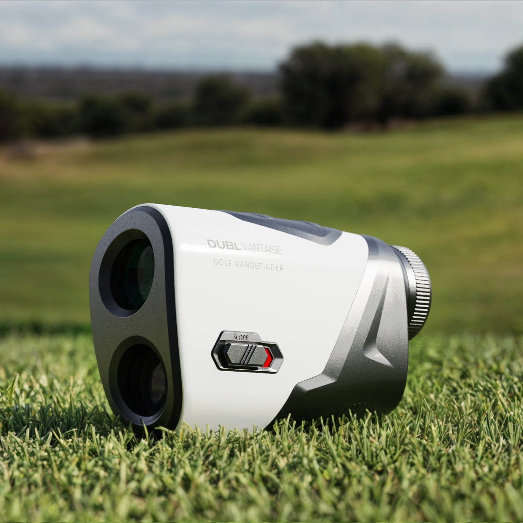 Golf rangefinder on grass with a blurred background