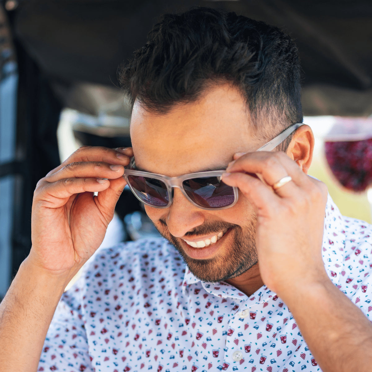 Matte Halo | Man adjusting golf sunglasses and smiling